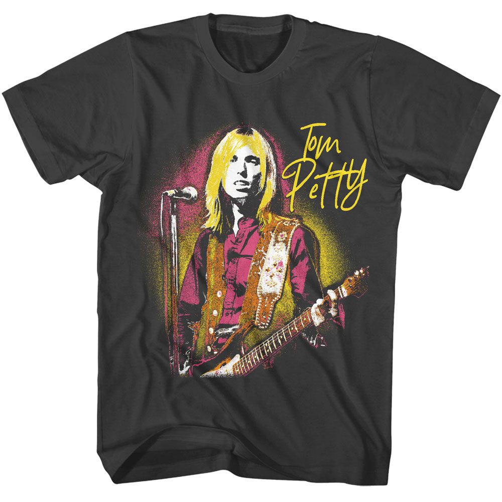 Black Tom Petty t-shirt featuring a vintage live performance portrait with Tom Petty holding a guitar and standing at a microphone, rendered in distressed yellow and magenta tones.