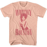 Blush pink Whitney Houston T-shirt featuring a monochrome portrait with large Whitney Houston lettering above and below