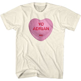 Cream-colored Rocky t-shirt featuring a pink candy heart with the words “Yo Adrian” in red lettering.